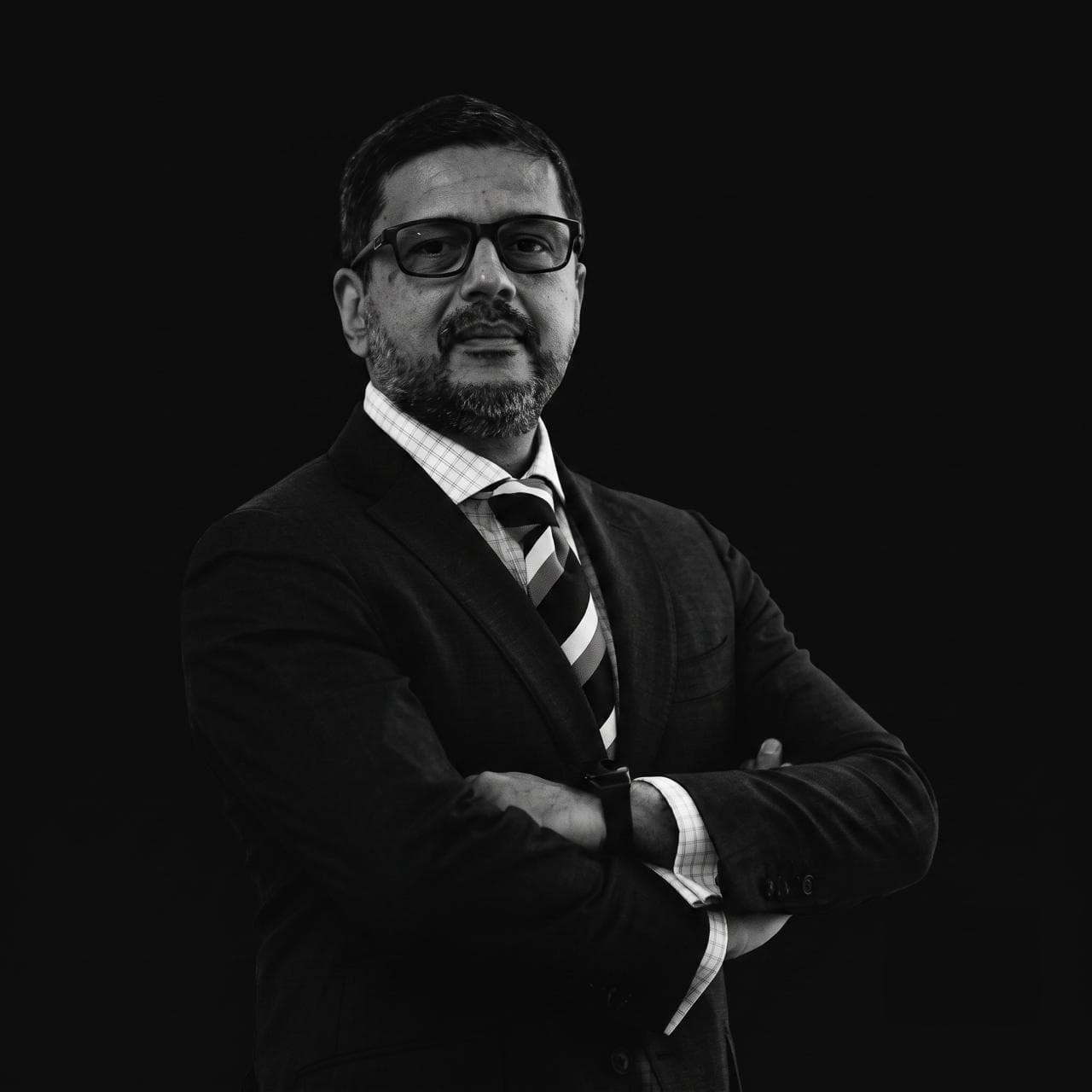 Somik Lall in a studio portrait, arms folded